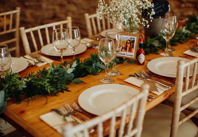 A table set with plates and greenery