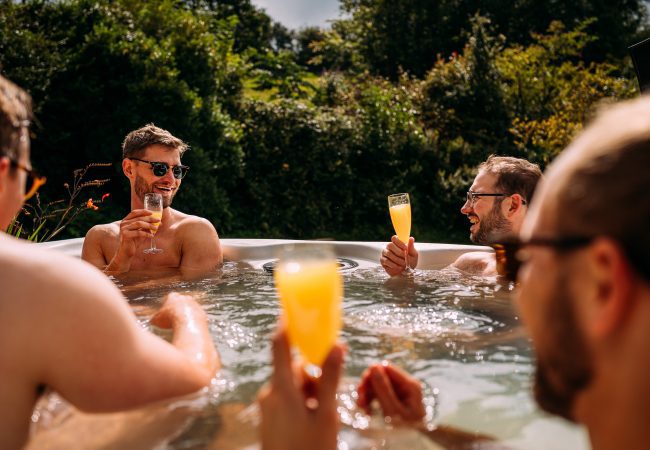 Men in a hot tube with glasses of organ juice