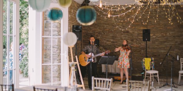 Guitarist and violin player in a barn