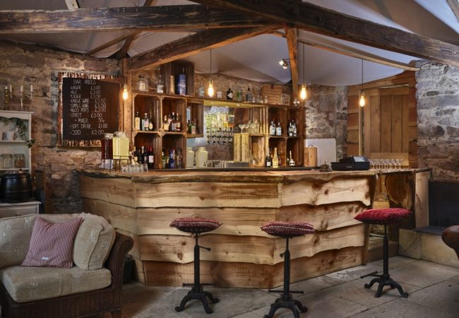 A wooden bar with stalls and drinks